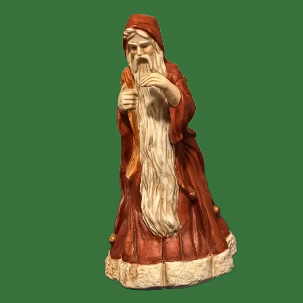 Incredible porcelain Santa carries his pack& wears a brownish robe.